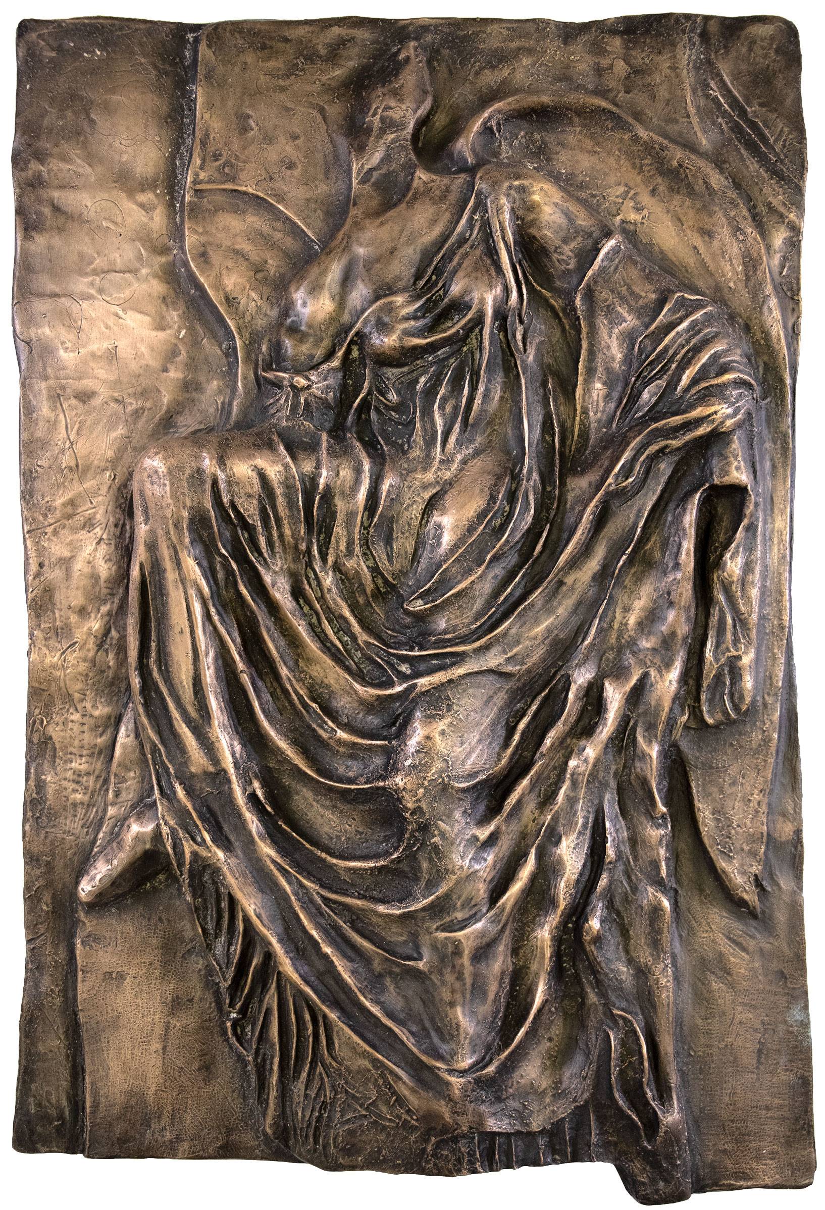 relief sculpture of female body drapped in fabric
